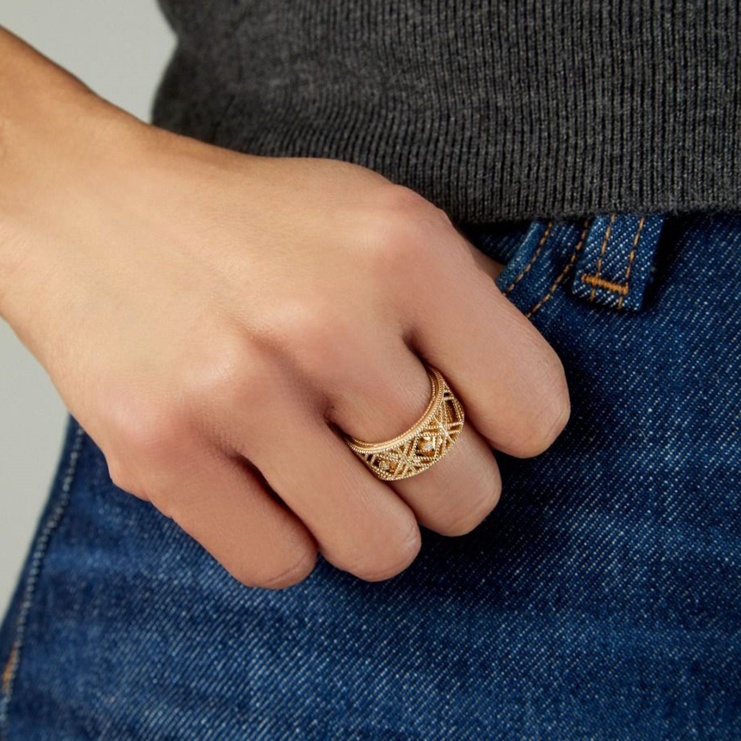 Textured diamond shape fancy ring in 14K yellow gold worn on a hand