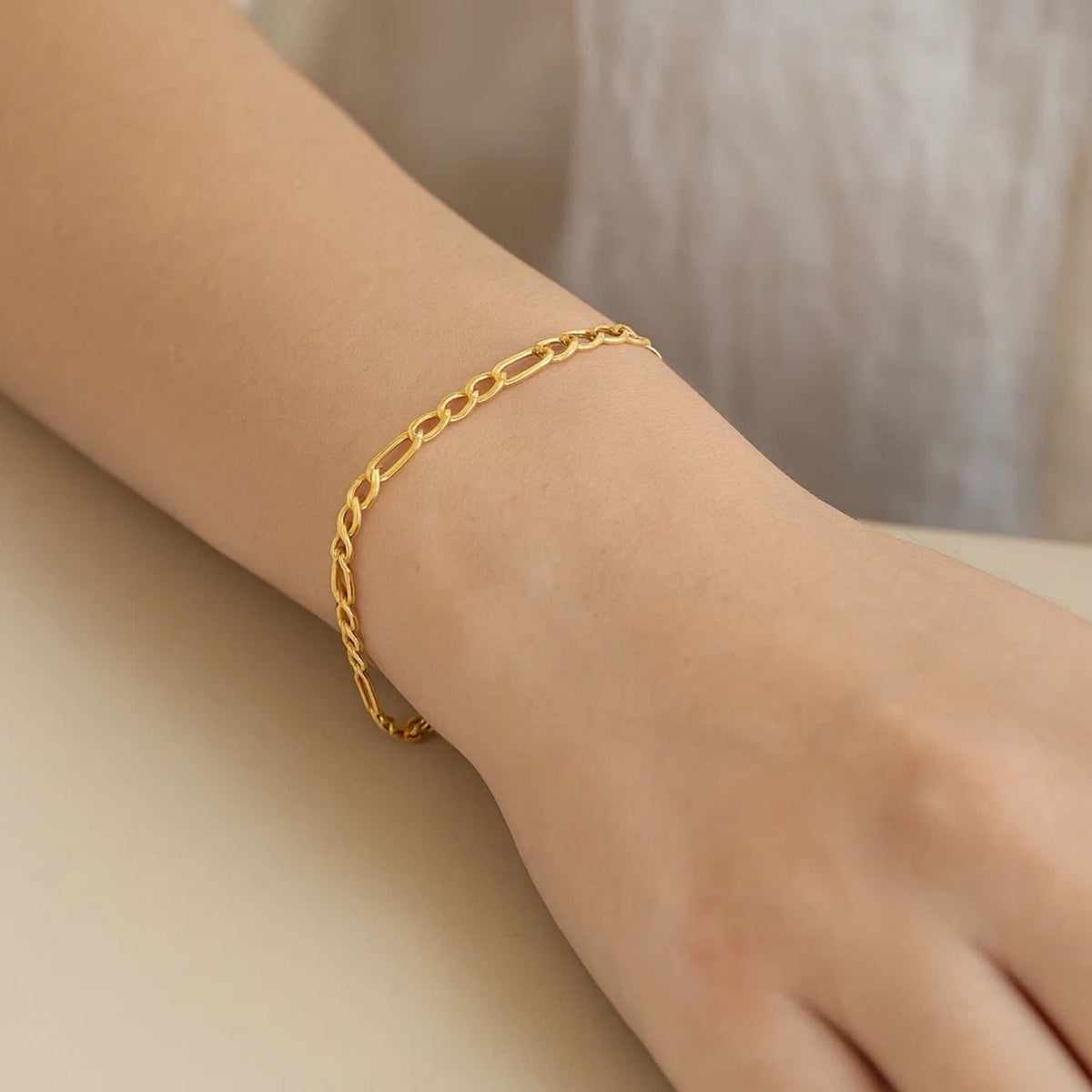 Lightweight Figaro Chain Bracelet in 14K Yellow Gold, worn