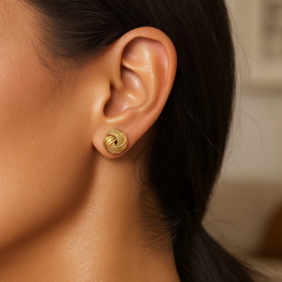Textured Love Knot Stud Earrings in 14K Yellow Gold, worn