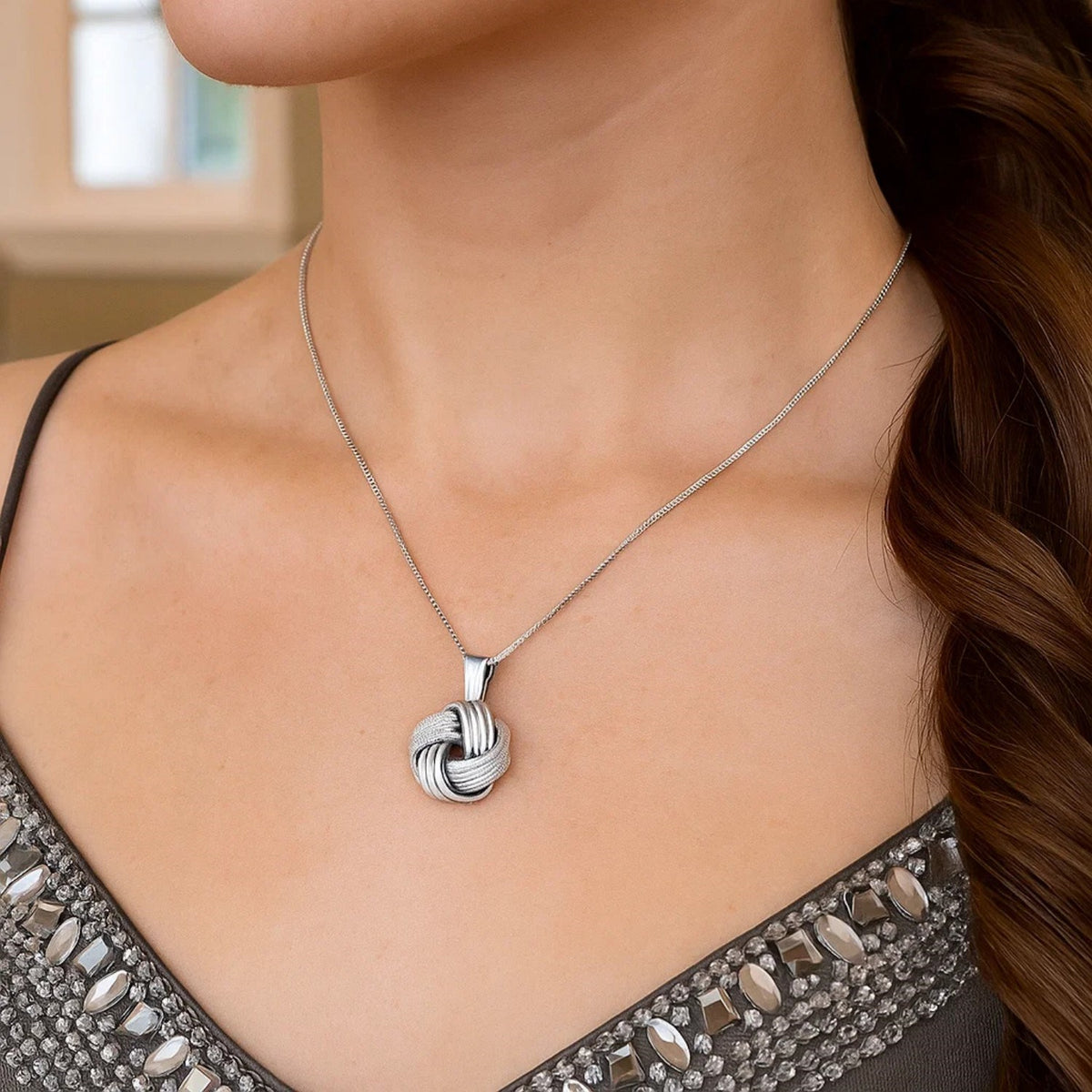 Textured Love Knot Pendant Necklace in Sterling Silver, worn