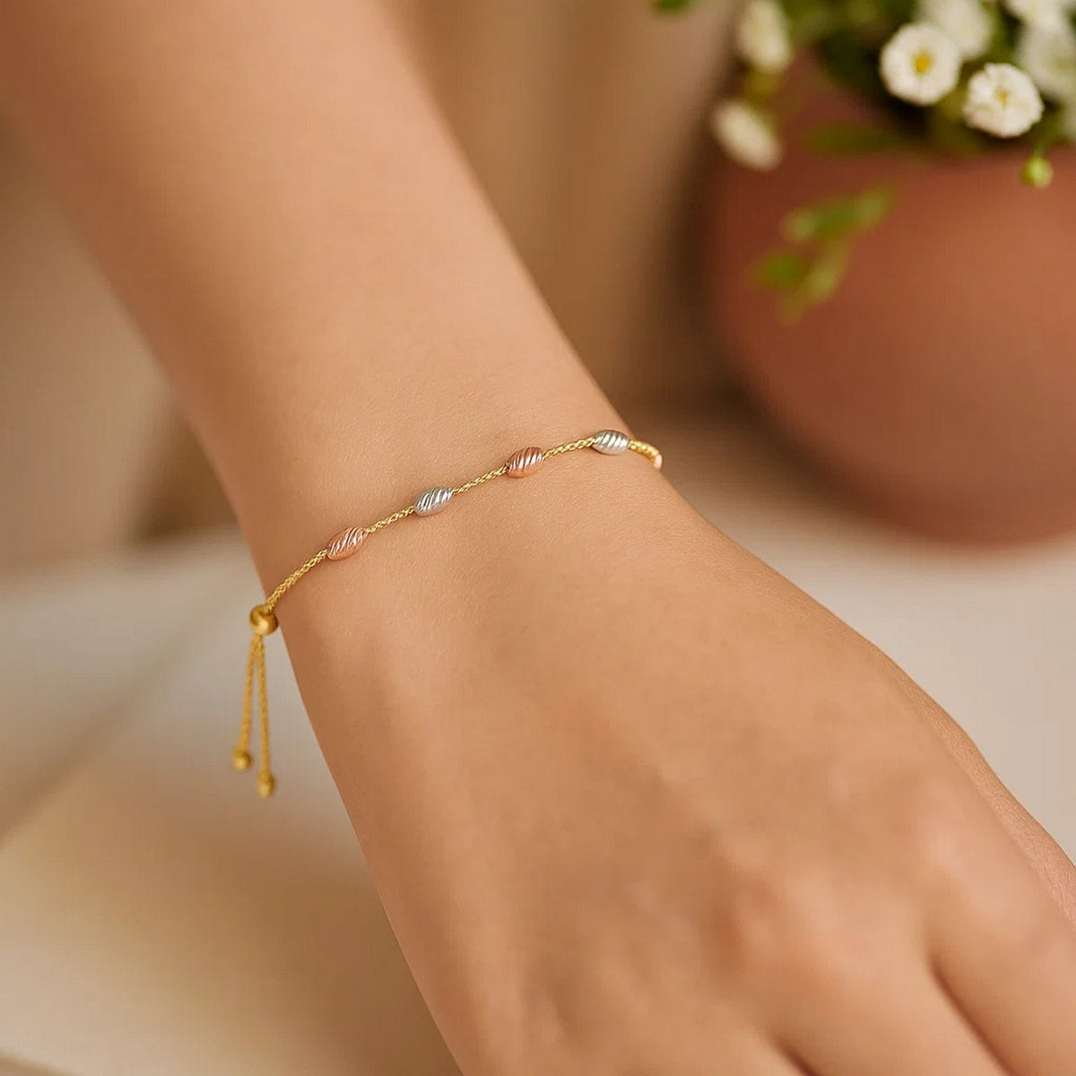 Diamond-Cut Oval Station Bolo Bracelet in 14K Tri-Color Gold, worn