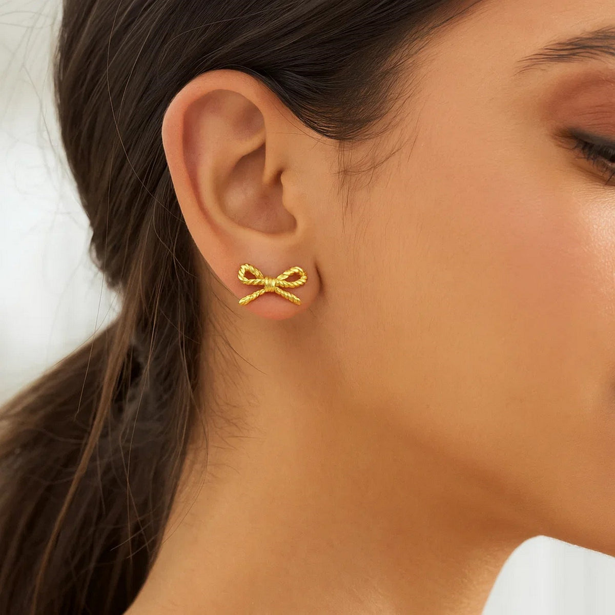 Rope Twist Bow Stud Earrings in 14K Yellow Gold, worn