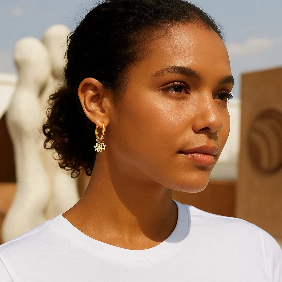 Star Charm Huggie Hoop Earrings in 14K Yellow Gold, worn
