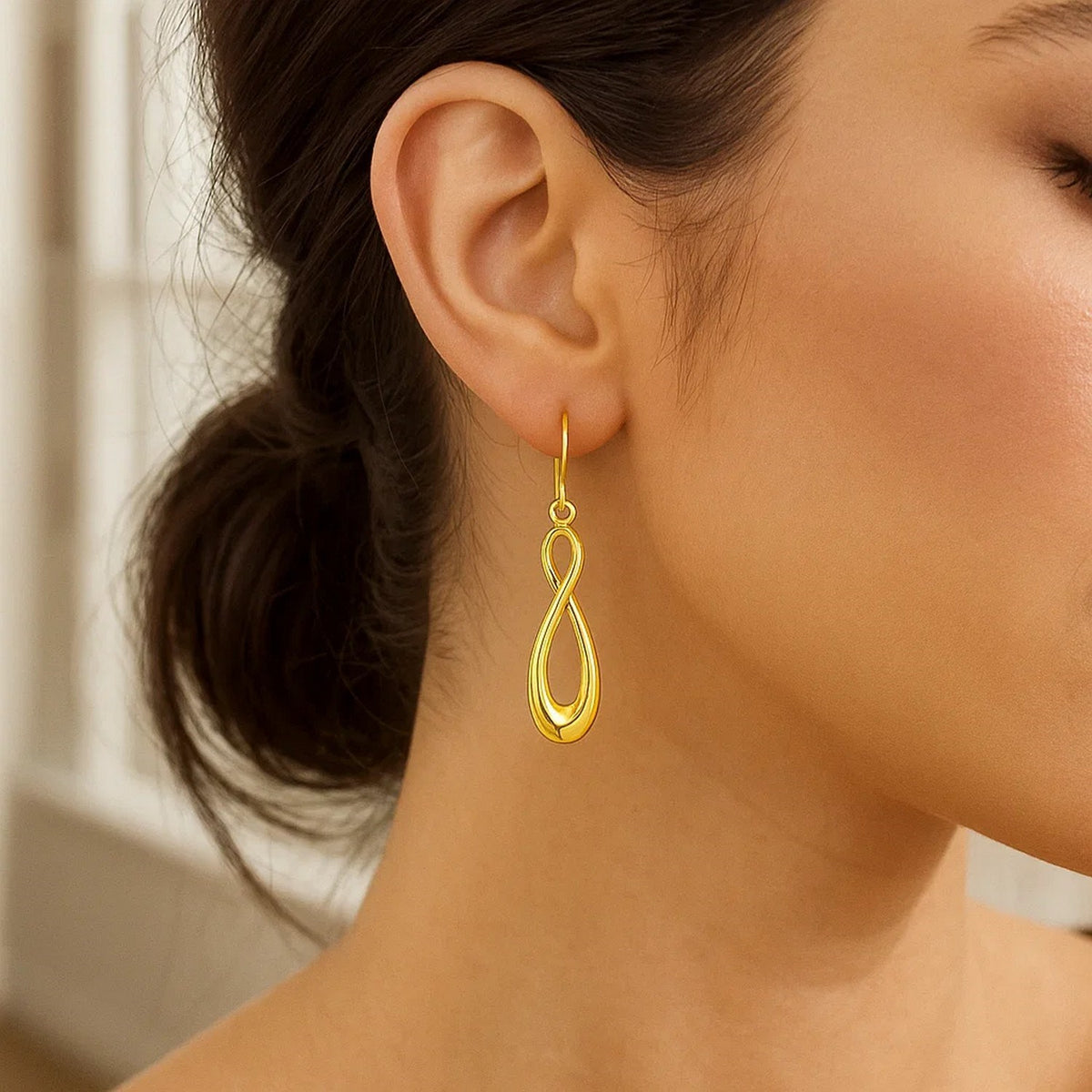 Polished Infinity Drop Earrings in 14K Yellow Gold, worn