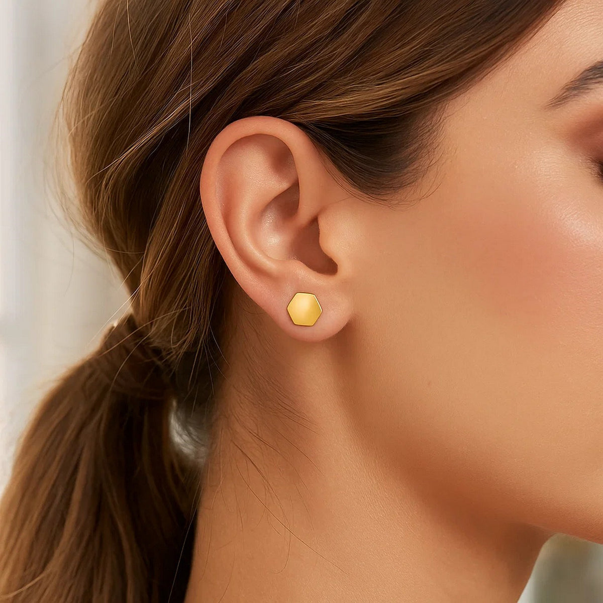 Polished Hexagon Stud Earrings in 14K Yellow Gold, worn