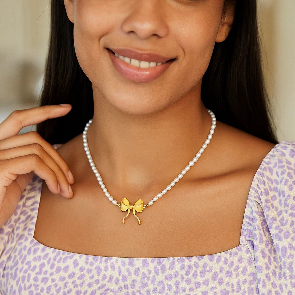 Pearl Strand Necklace with Gold Bow in 14K Yellow Gold, worn