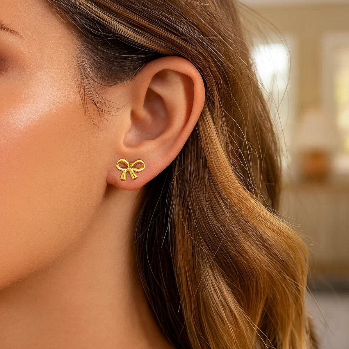 Polished Bow Stud Earrings in 14K Yellow Gold, worn