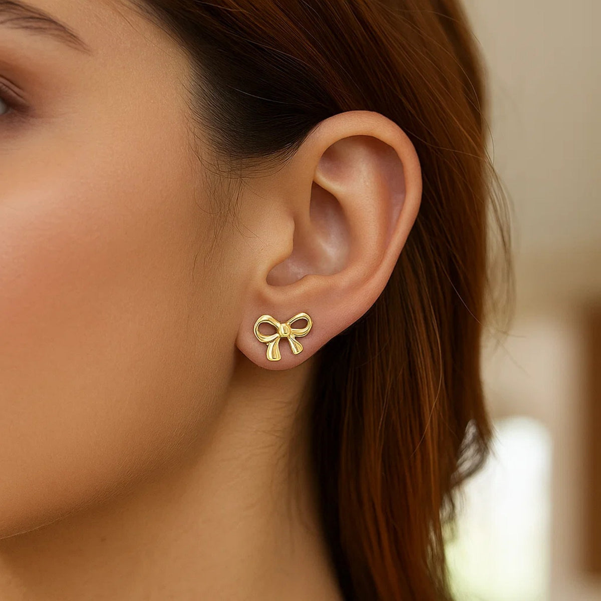 Polished Bow Stud Earrings in 14K Yellow Gold, worn