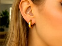Thick Huggie Hoop Earrings in 14K Yellow Gold — product video