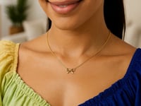 Small Polished Bow Necklace in 14K Yellow Gold — product video